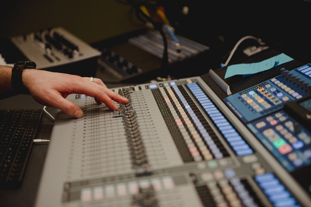 Sound engineer working at professional mixing console